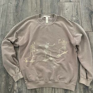 Brown urban sweatshirt with skeletons on skate board